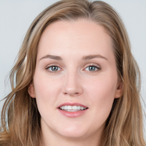 Joyful white young-adult female with long  brown hair and blue eyes