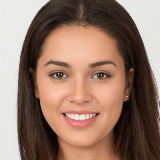 Joyful white young-adult female with long  brown hair and brown eyes