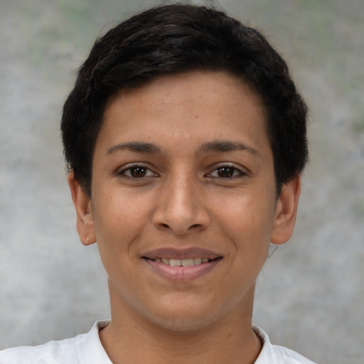 Joyful latino young-adult female with short  brown hair and brown eyes
