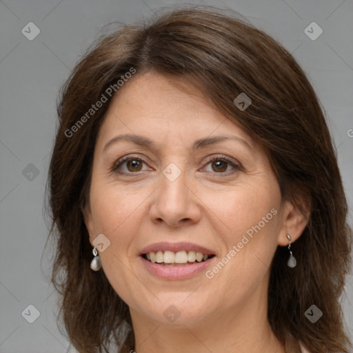 Joyful white adult female with medium  brown hair and grey eyes