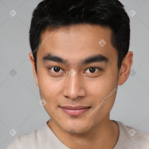 Joyful asian young-adult male with short  black hair and brown eyes