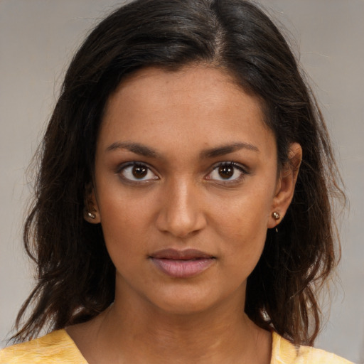 Joyful black young-adult female with medium  brown hair and brown eyes