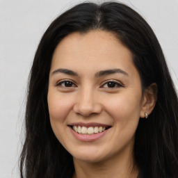 Joyful latino young-adult female with long  brown hair and brown eyes