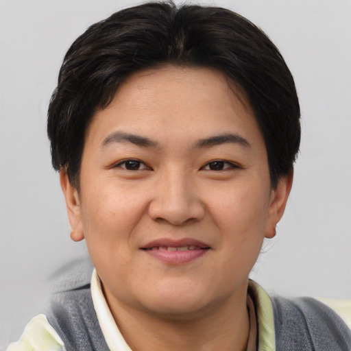 Joyful asian young-adult female with short  brown hair and brown eyes