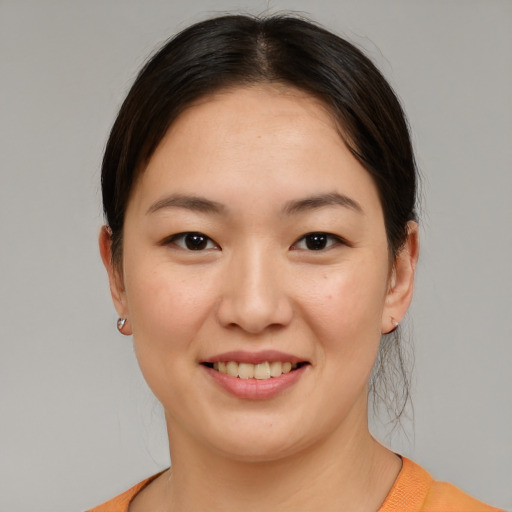 Joyful asian young-adult female with medium  brown hair and brown eyes