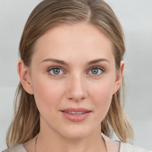 Joyful white young-adult female with medium  brown hair and blue eyes