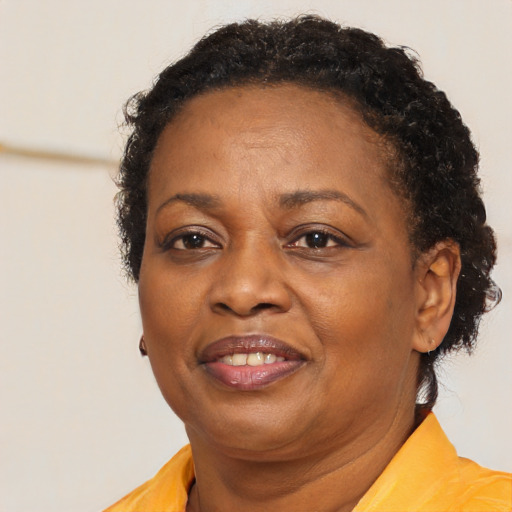 Joyful black adult female with short  brown hair and brown eyes