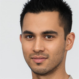 Joyful latino young-adult male with short  black hair and brown eyes