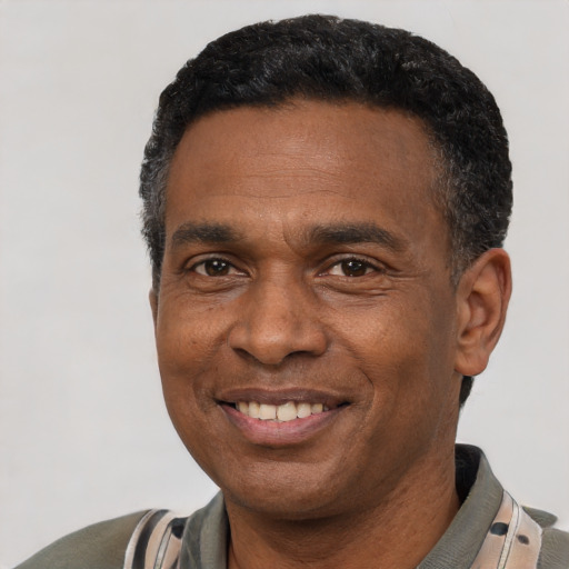 Joyful latino adult male with short  black hair and brown eyes
