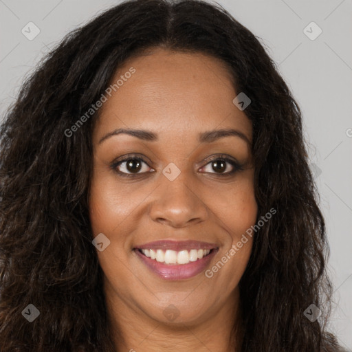 Joyful black young-adult female with long  brown hair and brown eyes