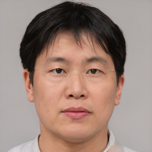 Neutral asian adult male with short  brown hair and brown eyes