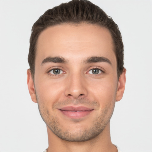 Joyful white young-adult male with short  brown hair and brown eyes