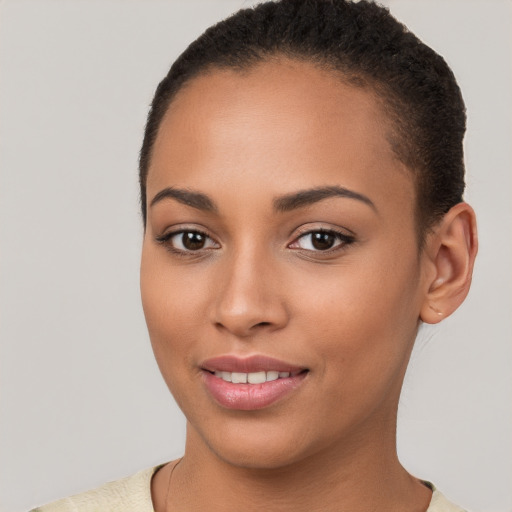 Joyful latino young-adult female with short  brown hair and brown eyes