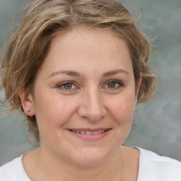 Joyful white adult female with medium  brown hair and brown eyes