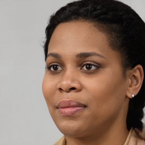 Joyful black young-adult female with short  brown hair and brown eyes