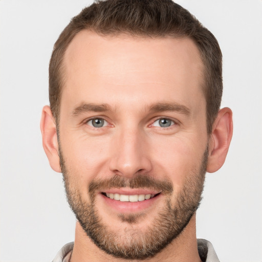 Joyful white young-adult male with short  brown hair and brown eyes