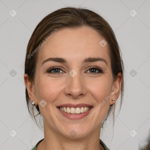 Joyful white young-adult female with medium  brown hair and grey eyes