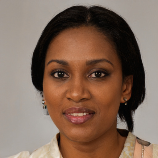 Joyful black young-adult female with medium  brown hair and brown eyes