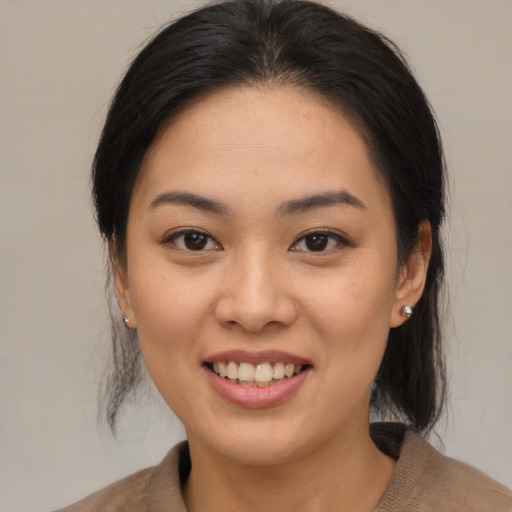 Joyful asian young-adult female with medium  brown hair and brown eyes