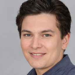 Joyful white adult male with short  brown hair and brown eyes