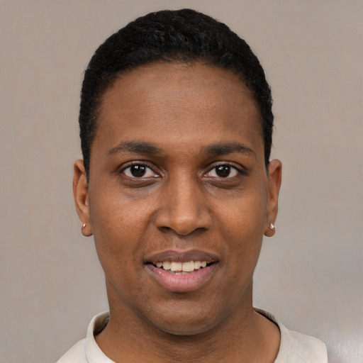 Joyful black young-adult male with short  black hair and brown eyes