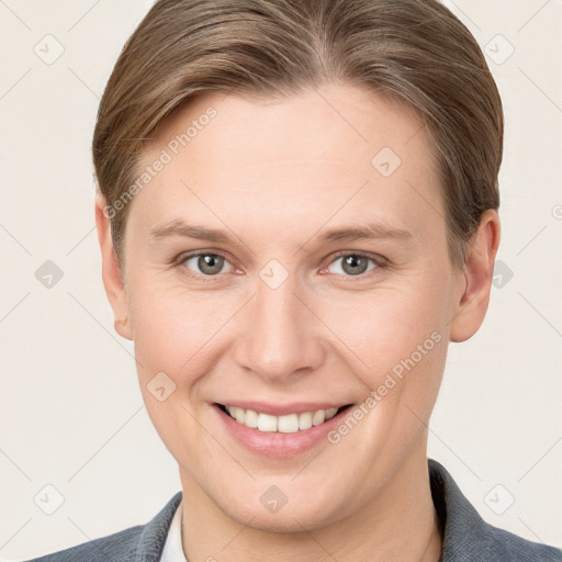 Joyful white young-adult female with short  brown hair and grey eyes