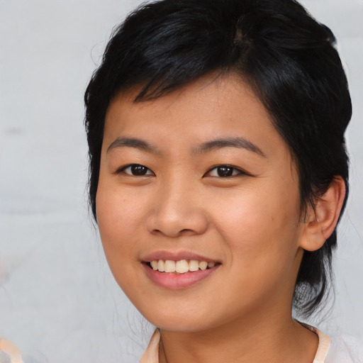 Joyful asian young-adult female with medium  black hair and brown eyes