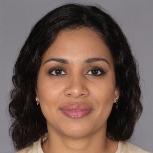 Joyful black young-adult female with medium  brown hair and brown eyes