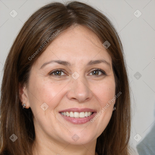 Joyful white adult female with long  brown hair and brown eyes