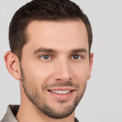 Joyful white young-adult male with short  brown hair and brown eyes