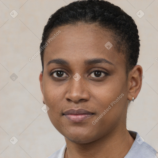 Joyful black young-adult female with short  black hair and brown eyes