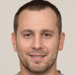 Joyful white young-adult male with short  brown hair and brown eyes