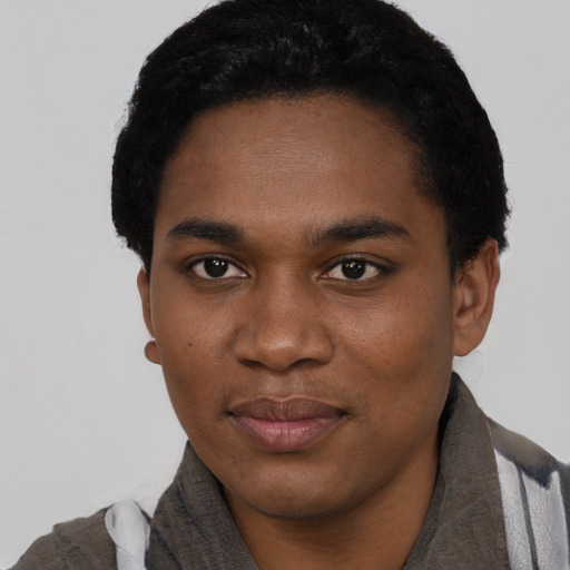 Joyful black young-adult male with short  black hair and brown eyes
