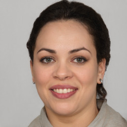 Joyful latino young-adult female with medium  brown hair and brown eyes