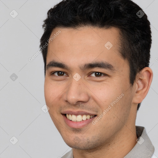 Joyful white young-adult male with short  black hair and brown eyes