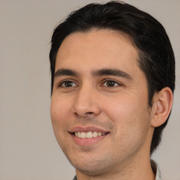 Joyful white young-adult male with short  black hair and brown eyes