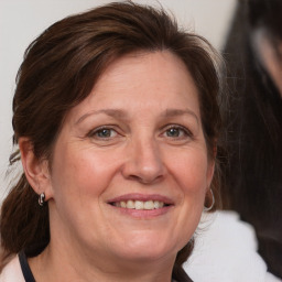 Joyful white adult female with medium  brown hair and grey eyes