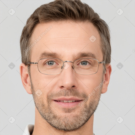 Joyful white adult male with short  brown hair and grey eyes