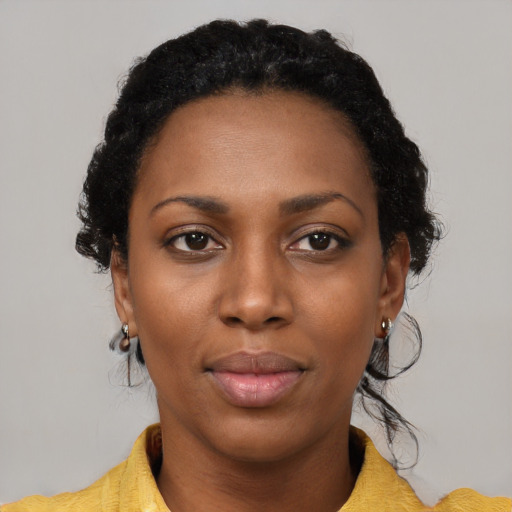 Joyful black young-adult female with medium  black hair and brown eyes