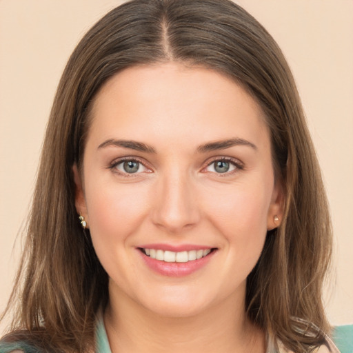 Joyful white young-adult female with medium  brown hair and green eyes