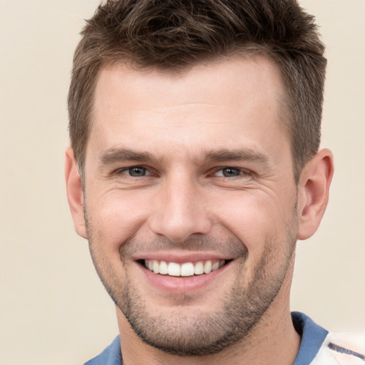 Joyful white young-adult male with short  brown hair and brown eyes