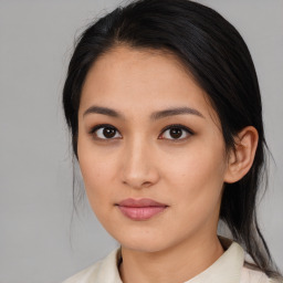 Joyful asian young-adult female with medium  brown hair and brown eyes