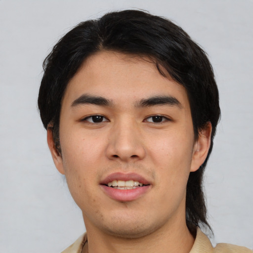 Joyful asian young-adult male with short  black hair and brown eyes