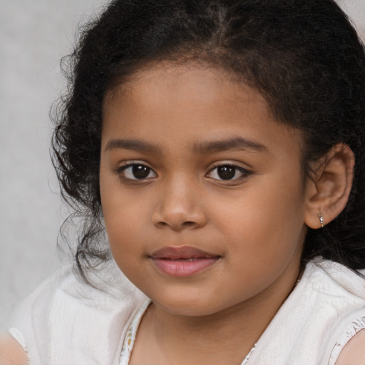 Joyful latino child female with long  brown hair and brown eyes