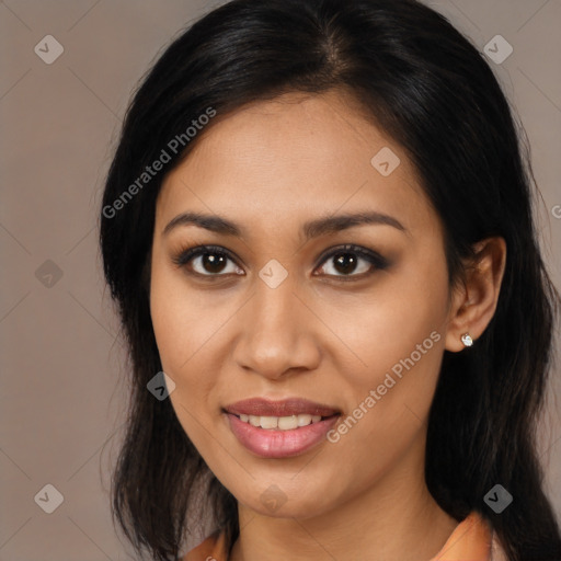 Joyful latino young-adult female with long  brown hair and brown eyes