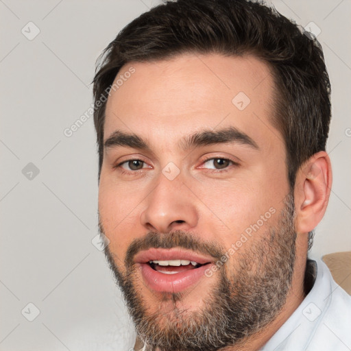 Joyful white young-adult male with short  black hair and brown eyes