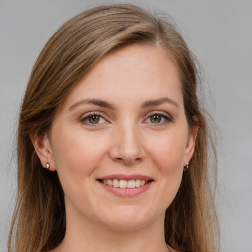 Joyful white young-adult female with medium  brown hair and grey eyes