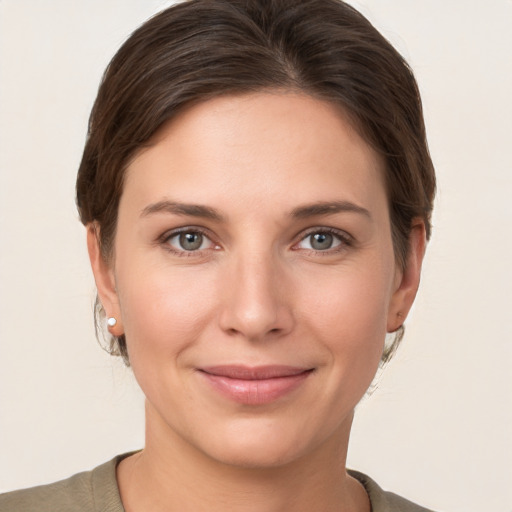 Joyful white young-adult female with short  brown hair and grey eyes