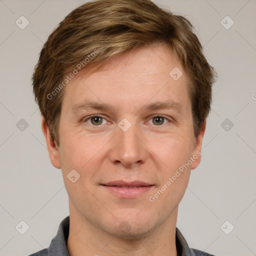 Joyful white adult male with short  brown hair and grey eyes