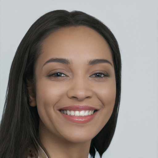 Joyful latino young-adult female with long  brown hair and brown eyes